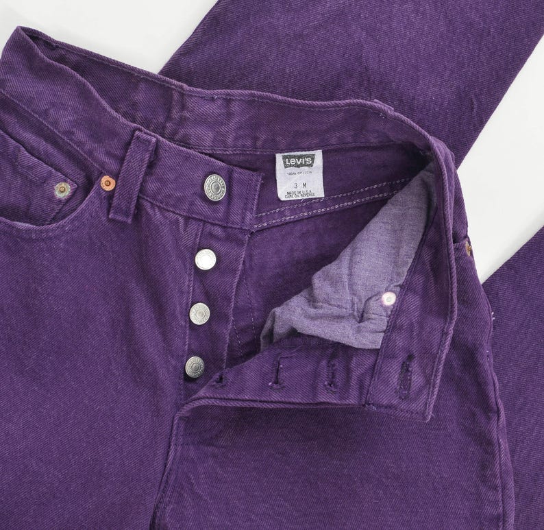 vintage 80s purple Levi's high waisted slim fit tapered leg jeans with button down fly. View of label inside of jeans.