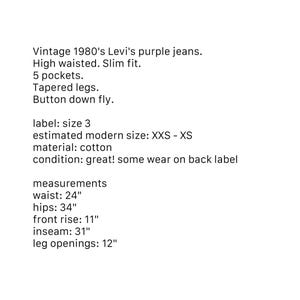May include: Vintage 1980's Levi's purple jeans with a high-waisted, slim fit. Features 5 pockets, tapered legs, and a button-down fly. Waist measures 24 inches, hips 34 inches, inseam 31 inches, and leg openings 12 inches. Made of cotton.