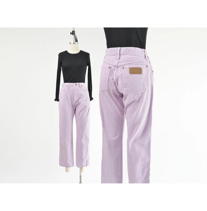 Vintage 90s western style Wrangler jeans. Light purple denim. High waisted. Straight legs. Displayed on dress form with a black t-shirt.