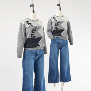 May include: A set of three ceramic mugs with a speckled, matte finish. The mugs are in shades of cream, light gray, and dark gray. Each mug has a simple, minimalist design, perfect for coffee or tea.