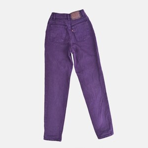vintage 80s purple Levi's high waisted slim fit tapered leg jeans with button down fly. Back view.