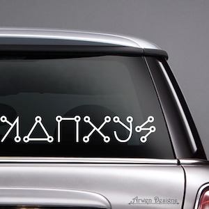 May include: A white vinyl decal with the word "MANX" written in a stylized font. The letters are made up of connected circles and lines. The decal is applied to the back window of a silver car.