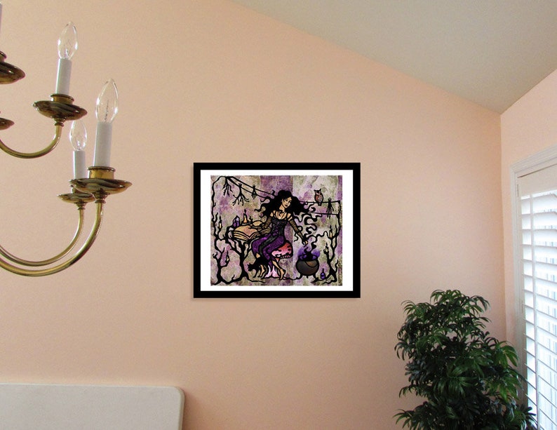 May include: A framed illustration of a woman with long dark hair wearing a purple dress and holding a cauldron. She is surrounded by trees and owls. The background is a purple and gray watercolor wash.