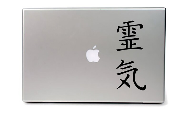 May include: A silver laptop with a black Apple logo and a black sticker with the Chinese characters "重要" and "気" on the back.