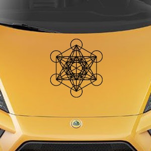 May include: A black and white geometric design of a sacred geometry symbol, the Flower of Life, on a yellow car hood.