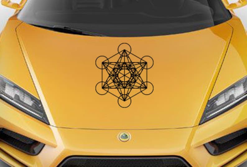 May include: A black and white geometric design of a sacred geometry symbol, the Flower of Life, on a yellow car hood.