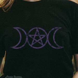May include: A black t-shirt with a purple triple moon and pentagram symbol. The symbol is a popular symbol in Wiccan and pagan traditions.