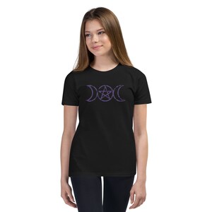 May include: A black t-shirt with a purple triple moon and pentacle design. The design is centered on the shirt.
