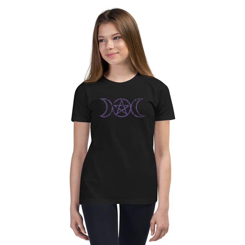 May include: A black t-shirt with a purple triple moon and pentacle design. The design is centered on the shirt.