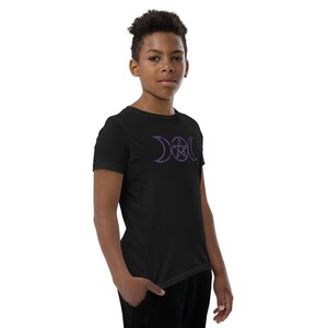 May include: A black t-shirt with a purple triple moon and pentacle design. The design is centered on the chest of the shirt.