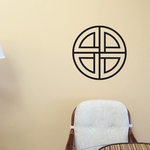 May include: A black and white wall decal of a circular geometric design with four intersecting lines.