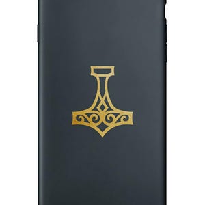 May include: A black phone case with a gold Mjolnir symbol, a Norse god's hammer, in a decorative design. The text "Airwen Designs" is at the bottom of the image.