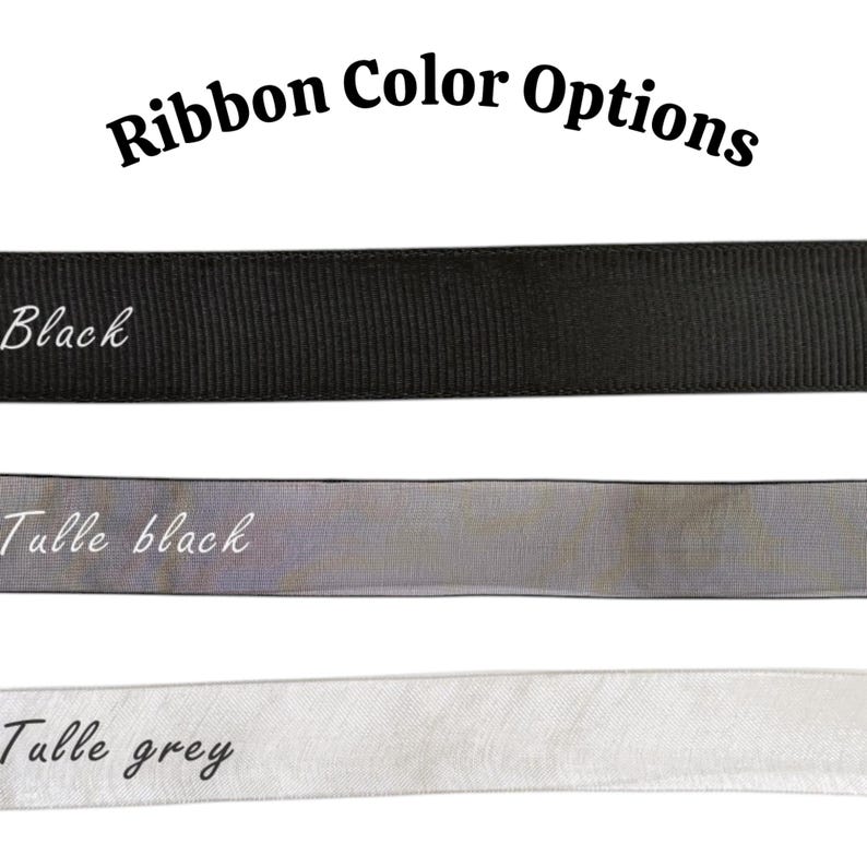 May include: Three horizontal ribbon strips labeled Ribbon Color Options. The top is a solid black grosgrain ribbon labeled Black. The middle is a sheer black tulle ribbon labeled Tulle black. The bottom is a sheer grey tulle ribbon labeled Tulle grey.