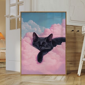 May include: A framed art print featuring a black cat sleeping peacefully amidst pink clouds against a blue sky. The cat is depicted with closed eyes, resting on a fluffy cloud. The artwork is framed in a gold-colored frame.
