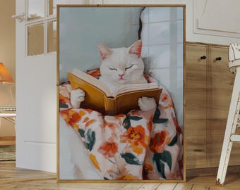 Puede incluir: Impresión enmarcada de un gato blanco leyendo un libro, envuelto en una manta floral. El gato, con los ojos cerrados, parece relajado. La obra de arte tiene un ambiente cálido, perfecto para la decoración del hogar.