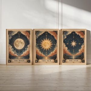 May include: Three framed art prints featuring celestial designs. Each print showcases a different celestial body: the Moon, the Sun, and the Star. The artwork has a vintage aesthetic with a color palette of blues, oranges, and gold.