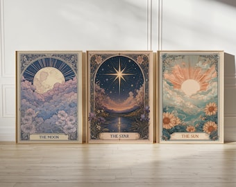 May include: Three framed art prints featuring celestial themes. The prints depict the moon, a star, and the sun, each with floral and cloud details. The text on the prints reads "THE MOON", "THE STAR", and "THE SUN". The frames have a vintage aesthetic.