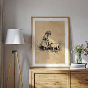May include: A framed monochrome illustration shows a child and a lamb in a field. The artwork is in a wooden frame and is displayed on a wooden cabinet. The style is reminiscent of a vintage sketch.