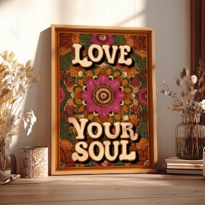 May include: A framed art print with the words "LOVE YOUR SOUL" in a retro font. The artwork features a floral mandala design in shades of pink, orange, green, and brown. The frame is made of wood.