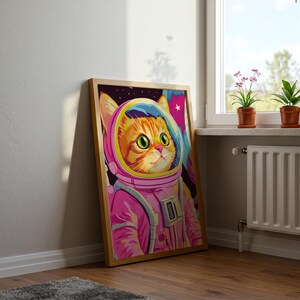 Funny orange cat wearing a pink astronaut suit in a colorful galaxy setting. This digital print combines pink poster aesthetics, dopamine decor energy, and girly prints charm. Ideal for fans of funny cat art, printable wall art, pink cat designs, and colorful wall arts. A playful coquette print perfect for cat lovers, space enthusiasts, and anyone who enjoys vibrant, happy decor.