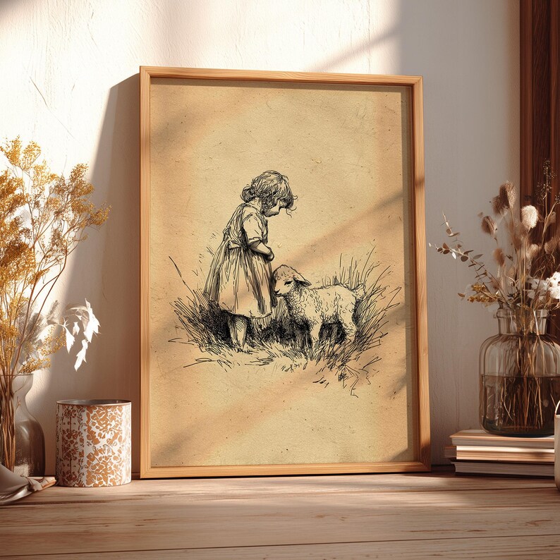 May include: A framed vintage print depicting a child and a lamb in a field. The black and white illustration has a sepia-toned background, set in a light brown wooden frame. The artwork evokes a pastoral, nostalgic theme, reminiscent of classic children's stories.