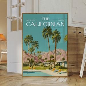 May include: A framed art print titled "The Californian" with a retro illustration of palm trees, a swimming pool, and mountains under a teal sky. The print includes the date "April 10, 1976".