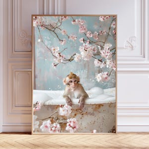 May include: A framed art print featuring a monkey in a vintage bathtub filled with bubbles. The background is a soft blue with cherry blossom branches. The monkey is light brown with a tuft of hair.