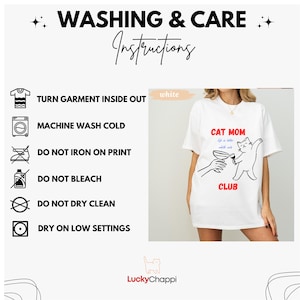 May include: White t-shirt with a cat graphic holding a wine glass, the words "CAT MOM CLUB" in red, and "Life is better with white cats" in blue. Washing instructions are also displayed.