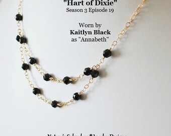 May include: A gold chain necklace with black beads. The necklace is layered and features a delicate chain. The text "As Seen On "Hart of Dixie" Season 3 Episode 19 Worn by Kaitlyn Black as "Annabeth" Nature's Splendour® Jewelry Designs" is visible in the image.