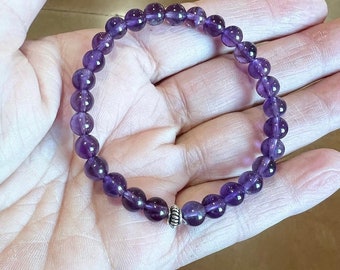 Amethyst Bracelet: Purple beaded stretch bracelet with silver Bali oxidized bead accent