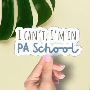 May include: A white sticker with blue text that reads "I can't, I'm in PA School".