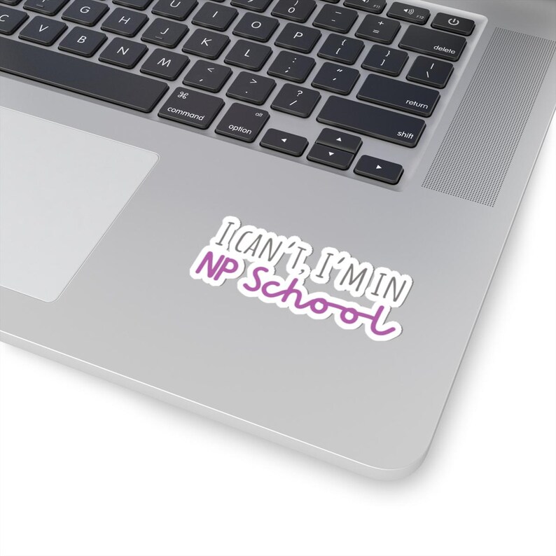 May include: A laptop computer with a sticker that reads "I can't, I'm in NP School". The sticker is white with pink text.