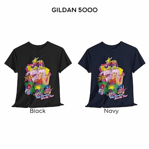 May include: Two Gildan 5000 t-shirts in black and navy, each featuring a graphic print of Jem and the Holograms with the text 1985 and Truly Outrageous World Tour. The design includes a central female figure with pink hair, a yellow star, and band members.