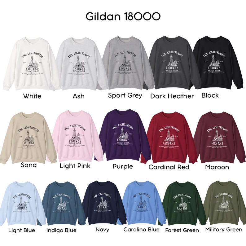 May include: A collection of Gildan 18000 sweatshirts in various colors, including white, black, and navy. Each sweatshirt features a lighthouse graphic with the text "THE LIGHTHOUSE LOUNGE".