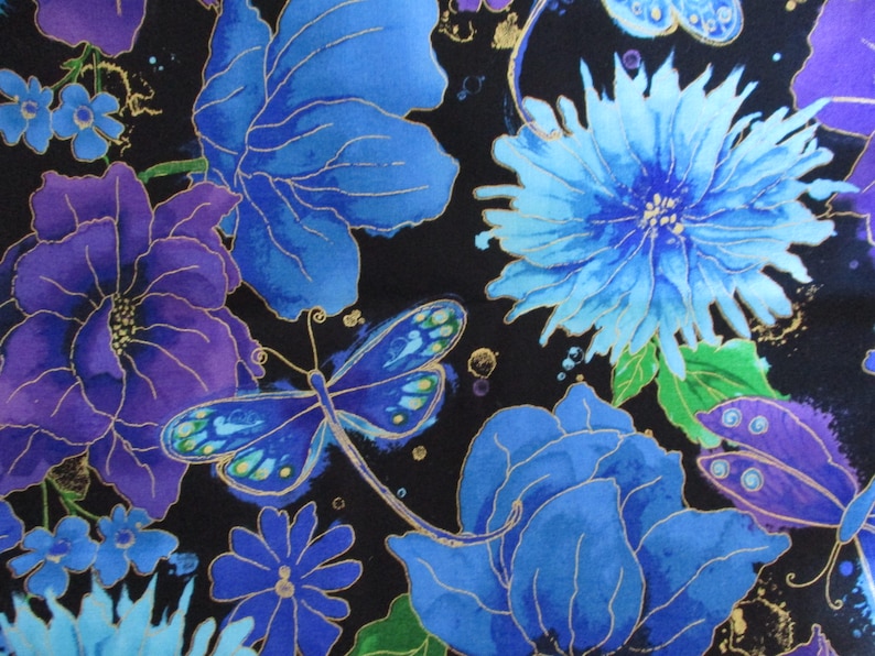 May include: A fabric with a floral pattern featuring large blue and purple flowers, dragonflies, and smaller blue blossoms against a black background. Gold accents highlight the details of the flowers and insects.