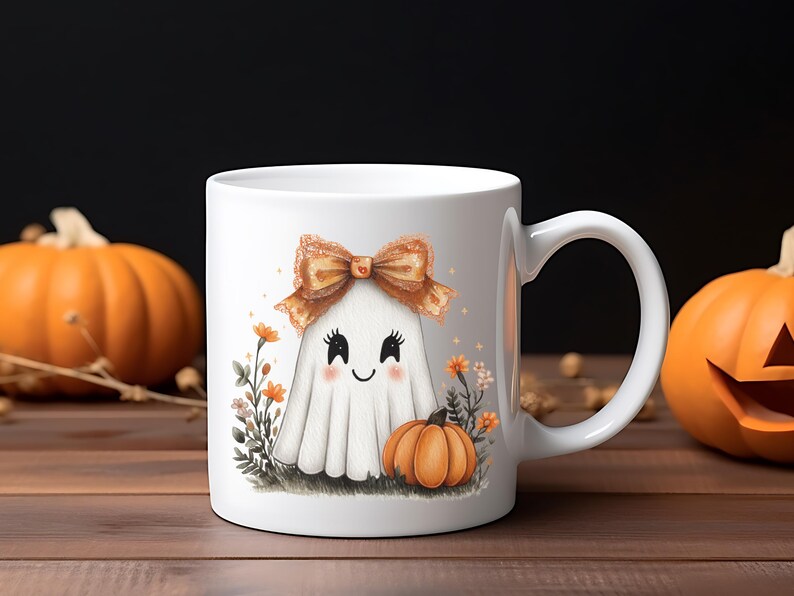 May include: White ceramic mug featuring a cute ghost illustration with a bow and a pumpkin. The ghost has a smiling face and is surrounded by flowers and another small pumpkin. The mug is a Halloween-themed product.