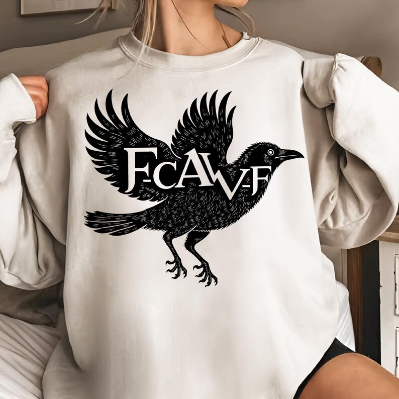 An iron-on transfer and sublimation design PNG file featuring an original gothic crow art graphic. This digital download is ready to be used for DIY crafts, especially for making custom t-shirts and hoodies. The design, which includes the iconic "F-CAW-F" text, is a high-resolution file that guarantees crisp, clean prints. It’s perfect for adding a touch of dark and mystical charm to your clothing or for creating memorable gifts for friends and family.