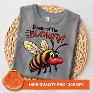 May include: A gray t-shirt with a cartoon illustration of a bee with red lips and the text "Beware of The BLOWFLY!" printed on it.