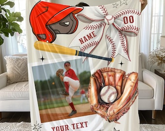 May include: A white fleece blanket featuring a baseball theme with a red batting helmet, a yellow baseball bat, and a brown leather glove holding a baseball. It includes a large photo of a baseball player, a decorative bow, and the text NAME and YOUR TEXT.