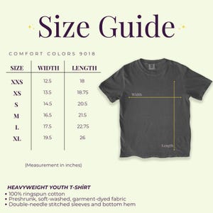 May include: A size guide for a heavyweight youth t-shirt, with measurements in inches. The guide includes sizes XXS to XL, with corresponding width and length measurements. The t-shirt is dark gray and made of 100% ringspun cotton.