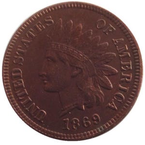 May include: A copper-colored one-cent coin with the words "United States of America" and the year "1869" inscribed on it. The coin features a profile of a Native American wearing a feathered headdress.