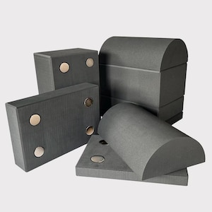 May include: A set of five gray foam blocks with rounded edges and a textured surface. Each block has four silver metal buttons on the top.