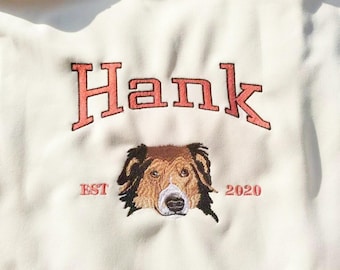 May include: White hoodie with a red embroidered logo that says "Hank est 2020" and a dog's head.