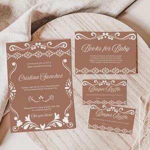 May include: A brown invitation suite for a baby shower. The invitation features a white floral design and the text "Come and join us for a Baby Shower honoring Cristina Sanchez". The other cards are for a diaper raffle and books for baby.