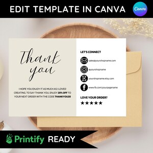 May include: A thank you card with the words "Thank you" in elegant script. The card includes contact information and a discount code. The card is on a wooden plate with a matching envelope.