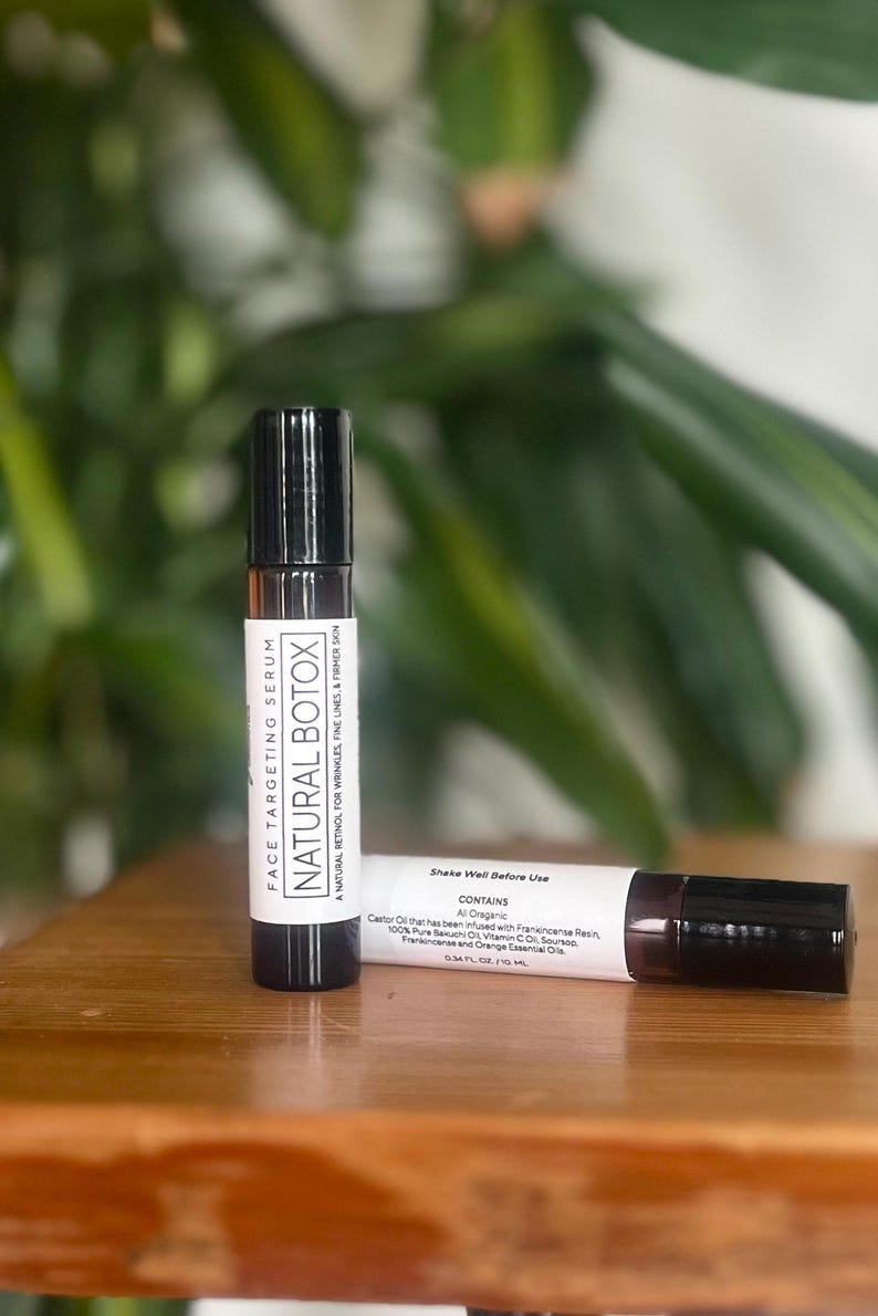 May include: Two small brown glass bottles with black roll-on tops. The bottles are labeled "FACE TARGETING SERUM NATURAL BOTOX" and contain a natural retinol for wrinkles, fine lines, and firmer skin. The label also says "Shake Well Before Use" and lists the ingredients as "All Organic Castor Oil that has been infused with Frankincense Resin, 100% Pure Bakuchi Oil, Vitamin C, Seabuckthorn, Frankincense and Orange Essential Oils".