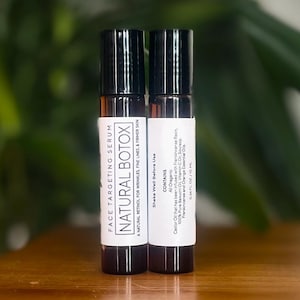 May include: Two brown glass bottles with black roll-on tops. The bottles are labeled "FACE TARGETING SERUM NATURAL BOTOX" and list the ingredients as "All Organic".