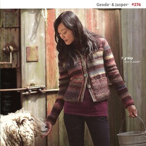 May include: A woman wearing a multi-colored striped cardigan with a burgundy shirt and black jeans. She is holding a metal bucket. The text "Geode™ & Jasper™ #276" and "1 g'day knit in Geode™" is visible in the image.