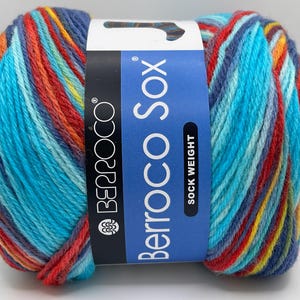 May include: A skein of Berroco Sock yarn in a multi-colored stripe pattern. The yarn is a sock weight and is labeled "Berroco Sox".