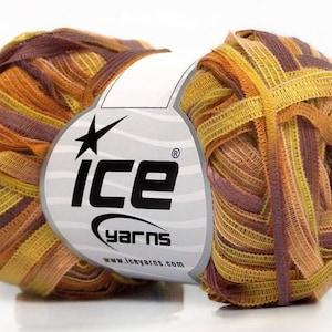 May include: A skein of multi-coloured yarn in shades of brown, orange, and yellow. The yarn is made of thin strips of fabric woven together. The skein is labelled "ICE yarns" with a star logo and the website address "www.iceyarns.com".